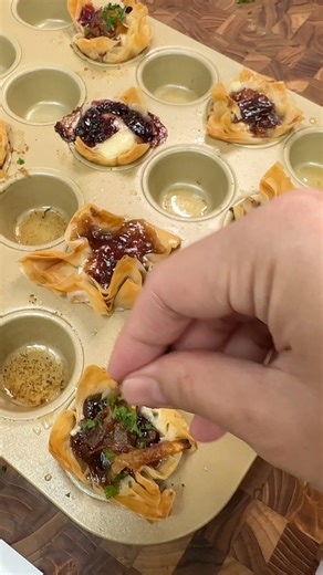 Mini Phyllo Cups using Bonne Maman spreads! Fig Cardamom - 5.5/10 Plum Pear Star Anise - 4/10 Cherry & Violet Leaves - 7.5 Instructions: Preheat oven to 350 degrees. Cut phyllo dough into squares with about 5-7 layers. Butter the mini muffin pan. Place phyllo squares into the pan. Place desired cheese, spread, and additional toppings. Brush phyllo dough with melted butter. Bake for 13-15 minutes. #snackideas #phyllodough #appetizers #bonnemaman #bakingrecipe #bakingideas #easyrecipeideas #viralf