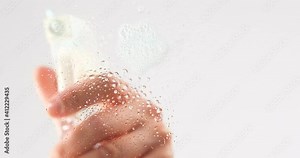 Green microfiber cloth.For wet and dry cleaning the glass table. Cleaning glass ground by spraying cleaning.. For wet and dry cleaning in the home and office.Woman hand.