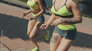 Running on stairs women doing run up on staircase. Close up of Female runner athlete climbing stairs in sport workout run outside in slow motion