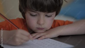 School Boy Practicing Writing Numbers at Home. Child Working on His Homework. Little Boy Studying Learning at Home. Child, Learning Doing Math for Education, Making Homework Numbers in His Room.