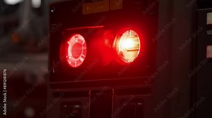 Closeup of an alarm blinking red signaling a malfunction in the production process.