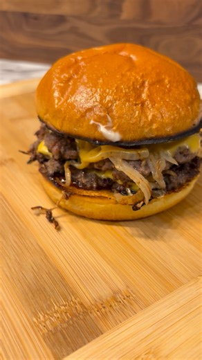 Keith / Dusty Roads BBQ on Instagram: "The Oklahoma Onion Smash Burger Using a griddle or flat top, lay down paper thin sweet onion slices. Then place 1/4 lb meat balls on top of the onions and smash them. Let the burgers cook until they start to grey on top - then flip them over. With the onion side up, lay down a piece of American cheese on each patty. Grill the buns until golden brown and get ready to assemble. Bottom bun. BBQ sauce. Double smash patty with cheese. Mayo on the top bun. Let’s