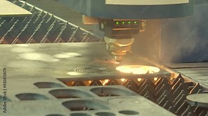 Demonstration of automated Laser CNC cut of metal with light beams technology modern industrial. High precision CNC Laser beam engraving cutting of heavy metal sheet with spark. Metal working plant.