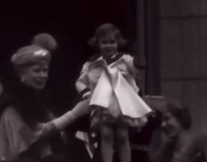 King George V of the United Kingdom lifting up his granddaughter Princess Margaret at the wedding of Prince George, Duke of Kent and Princess Marina of Greece, 1934. | Royal Tales