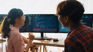 Slow motion back end software developer engineer for computer programming working together on debugging writing computing code, solving complex algorithms display on monitor in office. Burgeoning