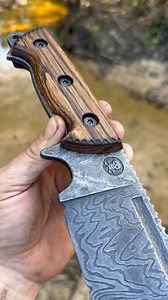 4.5K views · 266 reactions | Pirate Forge Rattler  this thing is bad to the bone… low layer chaos Damascus forged here in the shop.. fullers, freehanded ground jimping, stonewashed blade, weathered oak wood, Pyrography, and matte black corby bolts! #unique #forged #blacksmith #nativeamerican #outdoors #country | Pirate Forge | Facebook