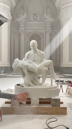 Architecture & Design on Instagram: "The “Pietà” is a sculpture by the Italian artist @Jago.Artist and was unveiled on 1 October in #Rome’s Church of the Artists. It is displayed in the Chapel of the Crucifix and can be seen until 28 February 2022. The sculpture is different from the classical iconography of the Pietà; Jago (Jacopo Cardillo), represents suffering, pain and deep sorrow of a man for the loss of a “beloved” woman whose abandoned body he holds strongly and desperately in his arms. #