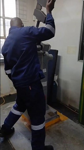 SWINGING AND DROPPING HEAVY MANUAL HAMMER ON IMPACT CHARPY TESTING MACHINE AT ROOM TEMPERATURE