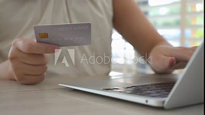 person enters credit card information to make an online purchase, carefully inputting the card number, expiration date, and security code. The process is secure, with encryption ensuring the safety