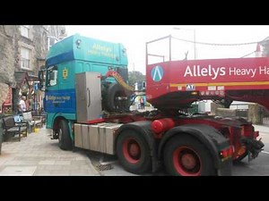 Train squeezes through narrow Barmouth streets on a lorry following fire on Barmouth Beach