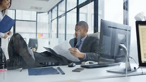 Laid back businessman with feet on the desk in the office