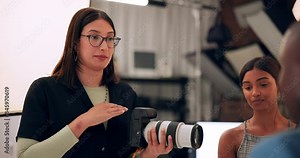 Photographer, woman and talking to model in studio with photoshoot planning, strategy and technique. Creative photography, backstage and collaboration with client for behind the scenes and set ideas