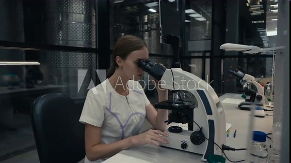 Using modern microscope equipment to perform the laboratory experiment. Examining the particles under the microscope for laboratory experiment. Microscope analysis of liquid for laboratory experiment.