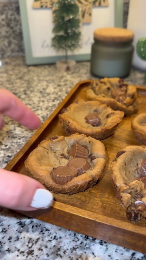 Chocolate chip cookie cups with reeses inside. I love this combo! #baking #dessert #easydessert #chocolatechipcookies #cookies #reeses @Reeses #desserthack #easybaking | Brooke AKA Meals and Munchies