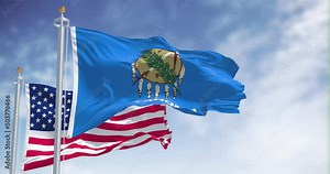 The Oklahoma state flag waving along with the national flag of the United States of America