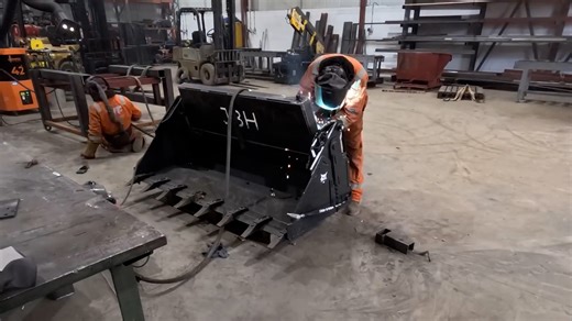 Fabricating heavy duty loader bucket in workshop