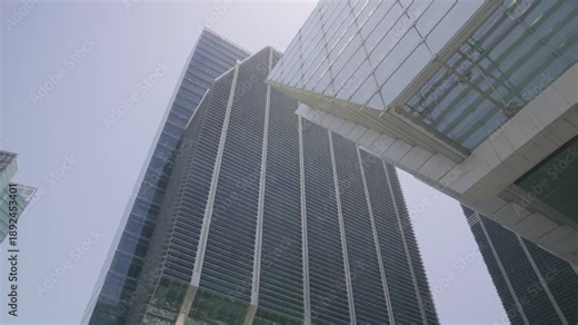 Cinematic tilt camera movement revealing the height and design of ADGM towers in Abu Dhabi, filmed in daylight using a mirrorless camera.