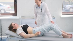 Doctor Conducting Abdominal Examination on Female Patient in Hospital Room