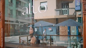 Coffee shop logo window close up. Clear glass entrance cafeteria reflecting city