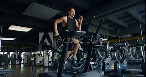 Strong athletic man doing intense cardio workout and running fast on treadmill at fitness club. Active sportsman male jogging at modern gym. Healthy lifestyle concept Stock Video