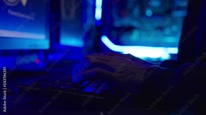 Closeup hand male hacker hacking into security systems. He typing on laptop keyboard and breaking password.