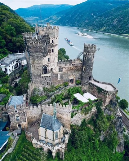 oldworldhistory on Instagram: "🛕The Rhine Castle (Burg Rhinestein) in Germany, a prominent medieval fortress perched on a steep cliff overlooking the Rhine River, was built around 1316/1317 and served as an important tax collection station. Photo by @hajkova.valerie"