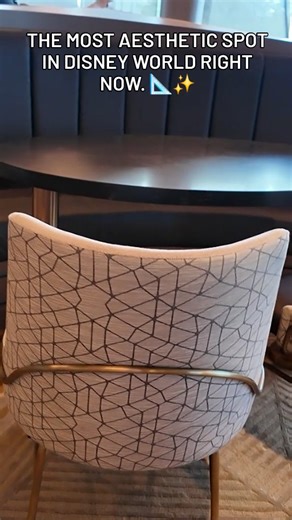 Continue the Magic on Instagram: "Have you seen the interior of the new Geo-82 lounge at EPCOT? 🌐 It’s hidden inside Spaceship Earth, and the design is a total love letter to 1982. The details are insane: ✨ "Warm Metallic" color palette (inspired by original concept art) ✨ Geometric chandeliers & triangular tiles everywhere ✨ Vintage Epcot prints on the walls ✨ Floor-to-ceiling views of World Celebration It feels like a mid-century modern time capsule mixed with 80s sci-fi. If you love Disney h