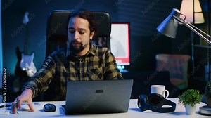 Man at home paying attention in elearning seminar teleconference with teacher, writing memo to remember later. Homeschooling student listening to lesson while taking note of weekend homework