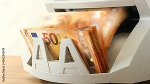Euro money. Counting euro banknotes with a money converting machine. Financial concept. Currency exchange, bank calculations, business settlements