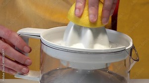 Squeezing a lemon with an electric citrus squeezer