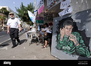 A man walks past a protest tent for the release of kidnapped Israeli soldier Gilad Shalit in Jerusalem, October 2, 2009.  Israel received a video of captured Israeli soldier Gilad Shalit on Friday in exchange for the release of 19 Palestinian women prisoners in a deal with Hamas.   UPI/Debbie Hill Stock Photo - Alamy