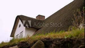 Windy day in Sylt Germany, roof and mansard of a white house