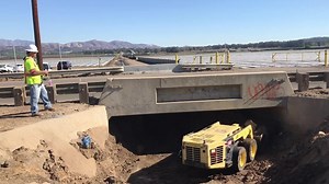 Watch how workers let this remote-controlled tractor do the dirty work
