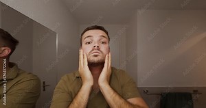 A realistic scene of a man standing in front of the bathroom mirror, examining his face and running his hands through his hair — a moment of self-reflection and daily routine