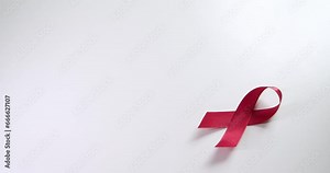 Placing a red ribbon on the right side of the frame which signifies the HIV-AIDS worldwide disease awareness and prevention.