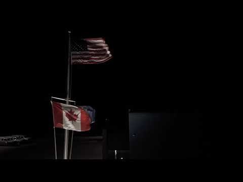 US and Canadian Flags Waving at Night | Border Crossing