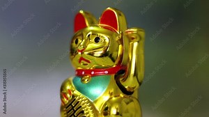 Maneki-neko - Chinese cat of luck with a waving paw