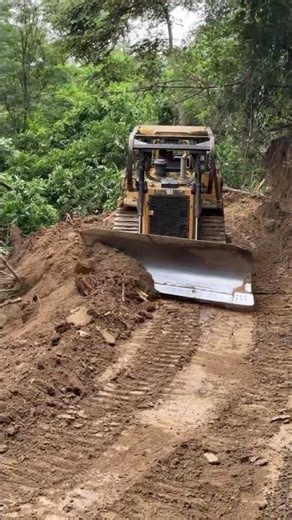 Road surface leveling process by bulldozer
