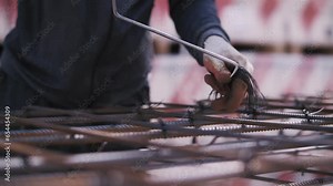 worker fastens the reinforcement with metal wire