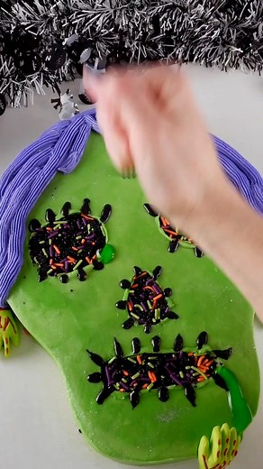 We're digging this zombie cake by cake pan, Coty Beth Cakes created with our Skull Shaped Cake Pan, Black Decorator Icing, Slime Green Glaze, Blood Red Glaze, Halloween Sprinkles, and Zombie Hands Decorating Kit.💚🧟 | Wilton Cake Decorating