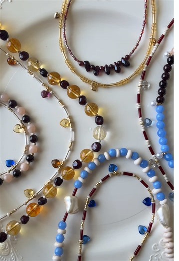 The DUO COLLECTION is just so pretty! Citrine gemstones, garnet nuggets, and these adorable glass heart charms make the coolest, yet unexpected color combos. Each pair features a statement piece and a dainty stacking necklace. #handmadejewelry #valentinesdayoutfit #gemstonejewelry #valentinesday #freshwaterpearls