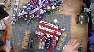 5.9K views · 101 reactions | Coach Mel is showing us how she made this pretty patriotic grapevine on a 16" frame, y'all! See which ribbons she choose to match her sign and how she brough in pops of glitter and patterns, too. Let us know what you think about the finished look down below! | DecoExchange | Facebook