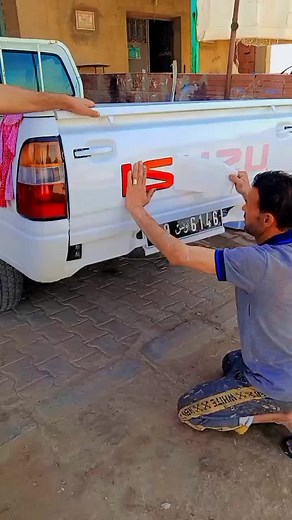 Decal Removal Process on White Isuzu Pickup Truck