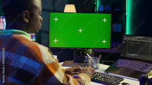 Developer enters binary data on terminal panel next to isolated mockup while he establishes html code. Software engineer works on troubleshooting with programming language, databases. Camera B.