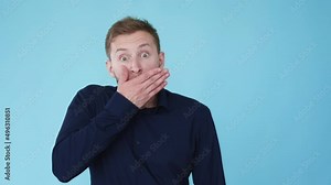Surprised man. Omg expression. Unexpected news. Boomerang animation. Astonished shocked guy hand covering mouth isolated on blue free space background GIF loop motion.