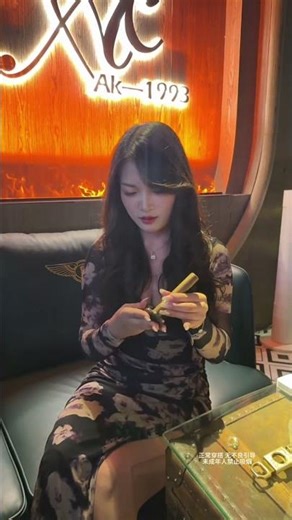 The richness of the cigar and her gentle service formed the most captivating scene in the club.