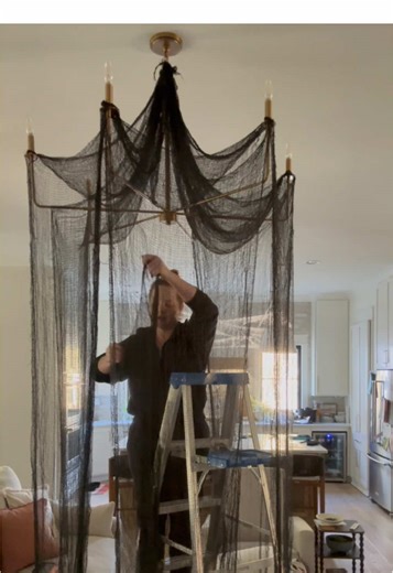Let’s design some dramatic pieces for our Halloween Party Saturday! I’m sharing how I made this gorgeous chandelier drapery for under $30 and a rubber band! #drapery #halloweendecor #halloweenparty