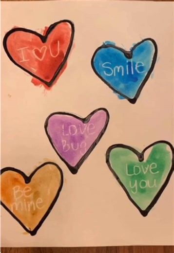 💛 Secret Conversation Hearts 💚 Conversation hearts are synonymous with Valentine’s Day, and this activity draws direct inspiration from the candy 🍬 I used a white crayon to write the secret messages inside each heart and then traced them with black glue (black glue = black paint mixed with white school glue). Once the glue was dry, I had my little use watercolors to paint each heart and reveal the secret message written inside 🖌 (The wax from the crayon repels the paint!) #valentinesday #kid