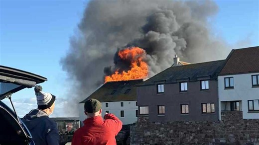 Huge fire erupts at Scots harbour as homes evacuated as cops warn 'avoid area'