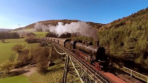 Mesmerizing View of Steam Engine Passage through Countryside